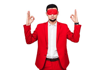 young businessman relies on luck, fortune. bearded man in a red suit with a red blindfold