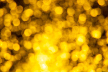 Golden glitter festive background with bokeh lights. Celebration concept for New Year, Christmas Holidays.