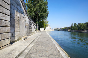 Paris, empty Seine river docks with steps in a sunny summer day