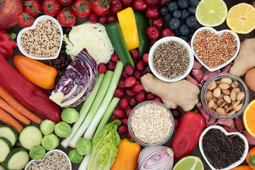 Super food concept for healthy diet with seeds, nuts, fruit, vegetables, cereal, herbs, and grains. Foods high in antioxidants, protein, anthocyanins, dietary fibre and vitamins. Top view.
