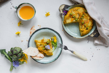 Spanish tortilla or potato omelette on white background, copyspace. Top view