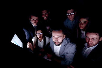 close up.a involved group of young people looking at a computer screen.