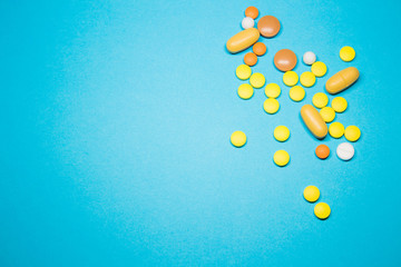 Colored pills on a blue background