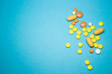 Colored pills on a blue background