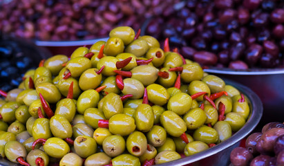 Green olive stuffed with red pepper close-up. Fruit and vegetable market. Selective focus