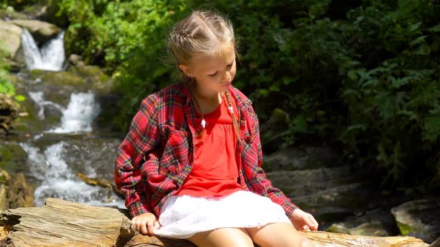 Little girl enjoying view of waterfall in Krasnay Poliana