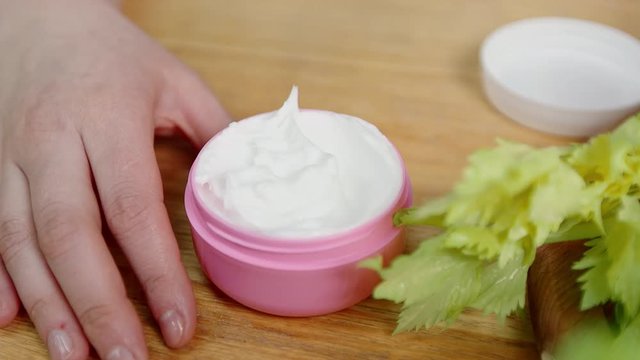 finger picking up cream