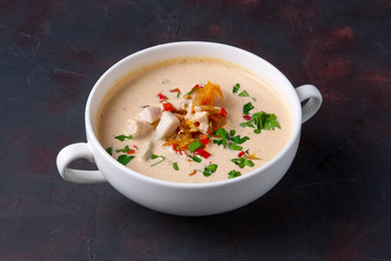 Soup puree with veal, fried onion, carrot and pepper