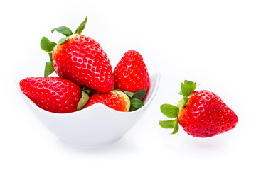 ripe strawberries in a white plate on a white background