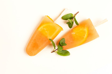 Homemade orange sorbet with orange slices inside and fresh mint