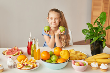 The girl eats fruit pineapple, watermelon, apples and drinks drinks from chia. Healthy food in the...