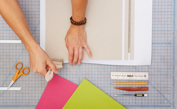 Two hands working on binding a book