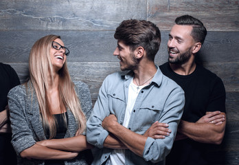 young people express different emotions standing at the wall