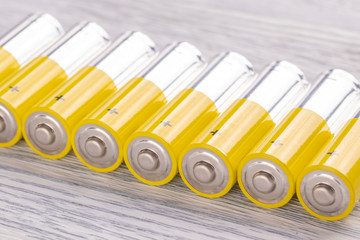 AA batteries on a white wooden table
