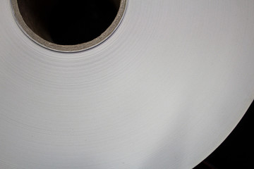 Roll of white paper on a cardboard shell..