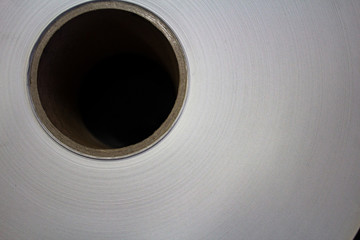 Roll of white paper on a cardboard shell..