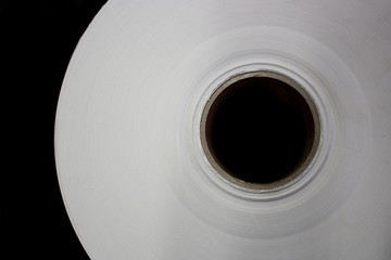 Roll of white paper on a cardboard shell..