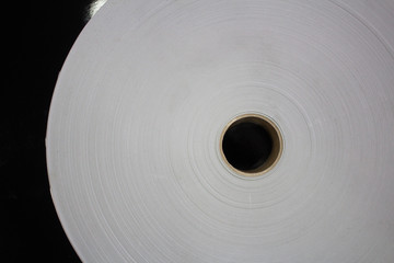Roll of white paper on a cardboard shell..