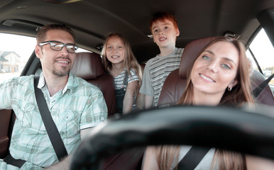 young parents go in the car