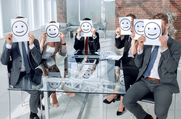 Business Team holding a paper with a positive smiley