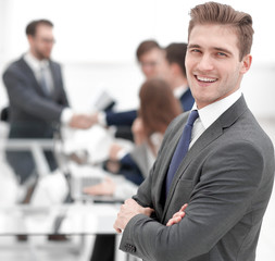 confident businessman on blurred office background