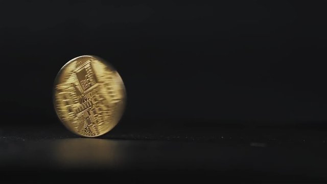 Gold bitcoin depreciation falling drop coin stacked against a dark background close-up. Bitcoin cryptocurrency in hand ethereum ico blockchain