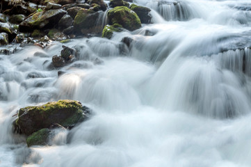 River in the mountains of the Swiss Alps in the Saint Luc valley on a sunny day.