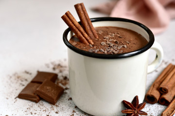 Homemade hot chocolate in a white enamel mug.