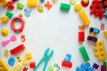 Children's toys and accessories on a white background. View from above © dyageleva