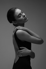 black and white photo of young woman  in black bodysuit torzo art posing beautiful skin fashion model  