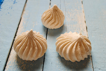 White meringues on a blue background