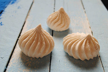 White meringues on a blue background
