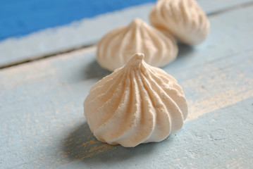 White meringues on a blue background
