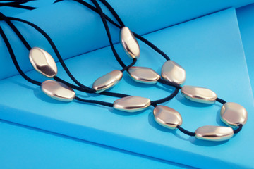 Fototapeta na wymiar modern necklace on blue