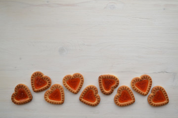 Romantic card with copyspace. Rustic white background with cookie hearts