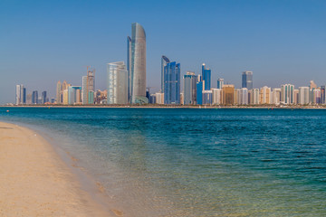 Fototapeta na wymiar View of the skyline of Abu Dhabi from the Marina Breakwater beach, United Arab Emirates