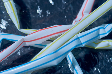 plastic waste. crumpled plastic film and cocktail tubes