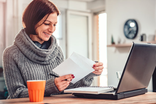 Woman Opening Letter In The Office