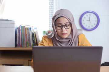 Muslim Businesswoman Working on Laptop at the Office