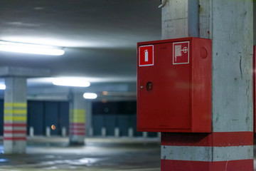 modern fire shield with a fire extinguisher on the parking wall