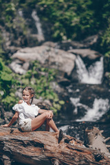 Little girl enjoying view of waterfall in Krasnay Poliana