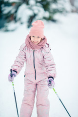 Child skiing in the mountains. Winter sport for kids.