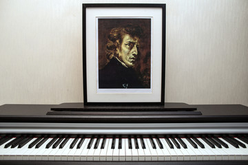 Fototapeta na wymiar 11.28.2018, Moscow, Russia. Fryderyk Chopin - Photocopy of portrait painted by Ferdinand Victor Eugène Delacroix in 1838 and piano keyboard. 