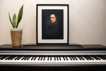 Fototapeta na wymiar 11.28.2018, Moscow, Russia. Franz Liszt - Portrait's photocopy of Ary Scheffer painted in 1837 and piano keyboard.