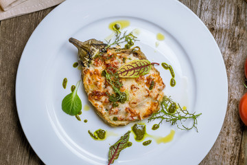 baked eggplant on plate with parmesan