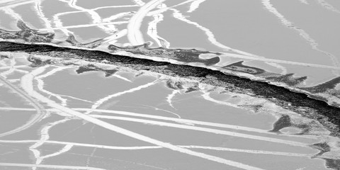 Tracks - Gaps and cracks form in thin surface ice on Emerald Bay. Lake Tahoe, California, USA