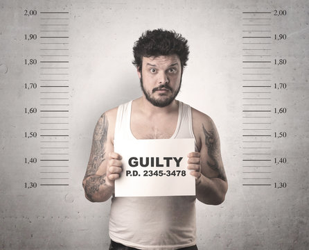 Caught guilty man with ID signs on his hand.