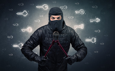 Burglar standing with tools in his hand.