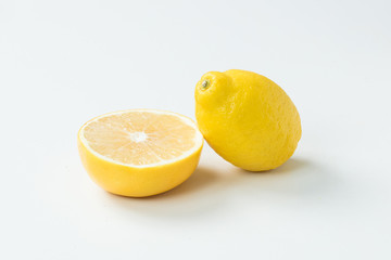 白背景に置いて半分に切ったレモン