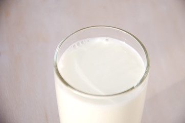 milk in a glass on a wooden background